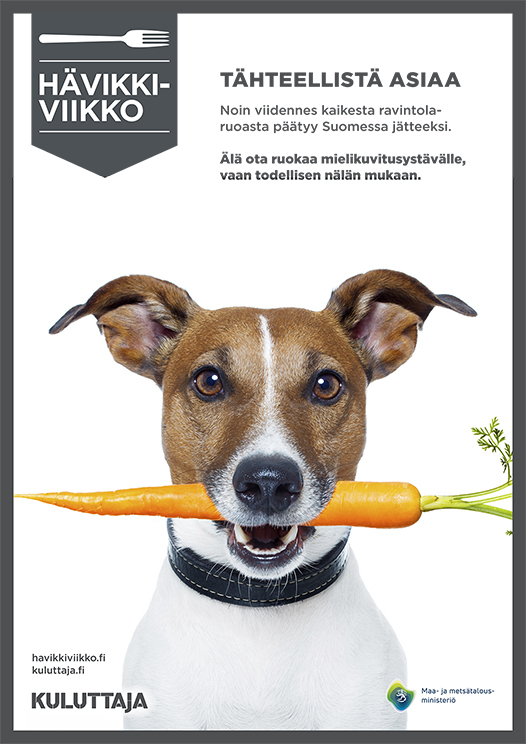 Hävikkiviikon mainoksessa koira, jonka suussa on porkkana.