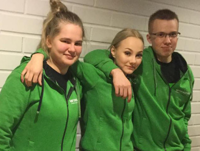 Sofia Ålander kahden opiskelukaverinsa kanssa pukeutuneena WinNovan vihreään huppariin.