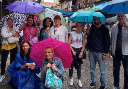 Nine teachers from different European countrien in Palermo Erasmus+ course. It's rainy day and everyone has an umbrella when tey visited Palermo city.