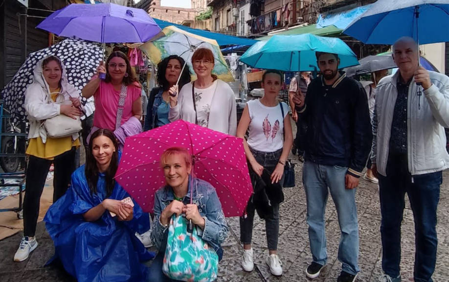 Nine teachers from different European countrien in Palermo Erasmus+ course. It's rainy day and everyone has an umbrella when tey visited Palermo city.