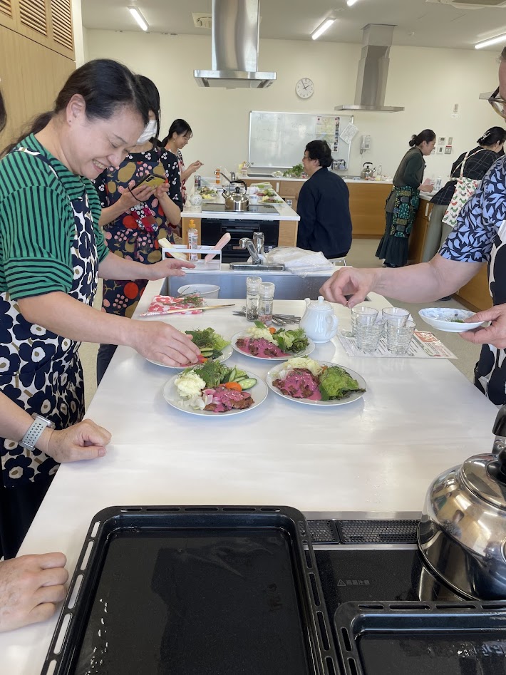 Suomi-workshopin japanilaiset osallistujat valmistavat yhdessä Lindströmin pihvejä.